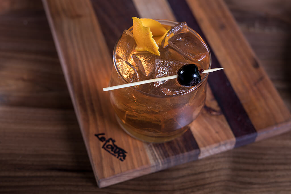 bourbon drink with cherry and orange peel